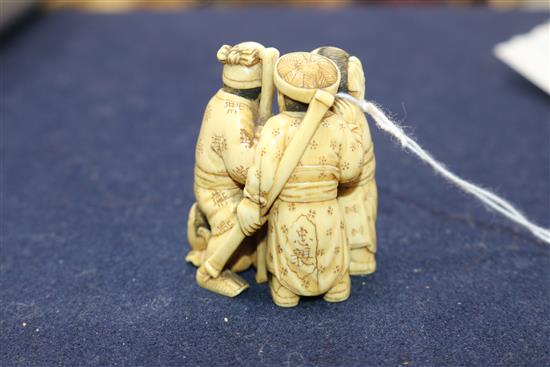 A Japanese ivory okimono carved with three figures height 6.5cm